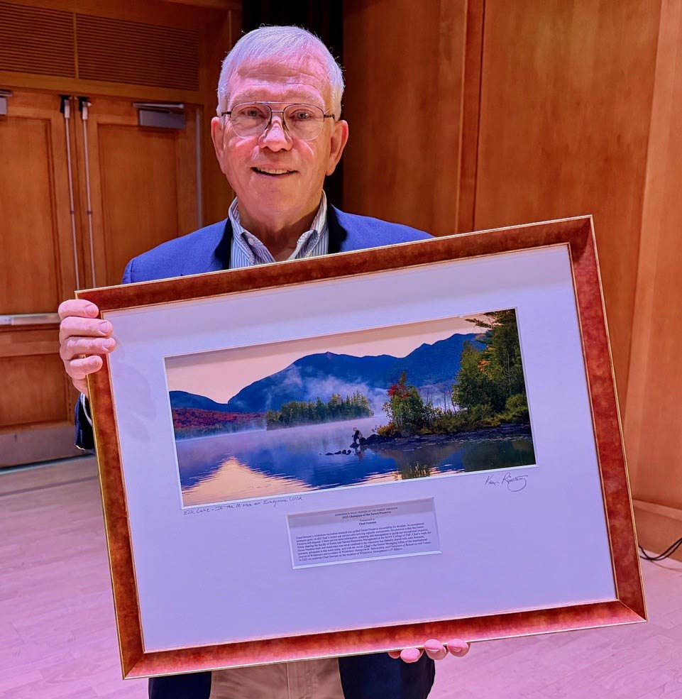 Chad Dawson, holding a framed award and smiling