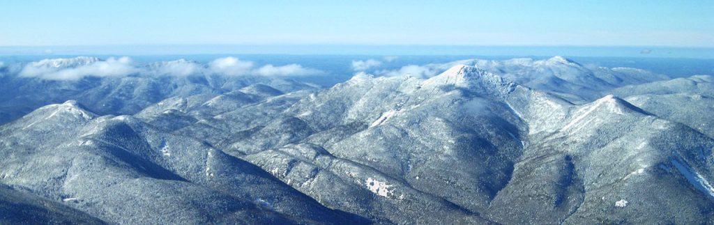 An aerial view of several snow covered mountain peaks