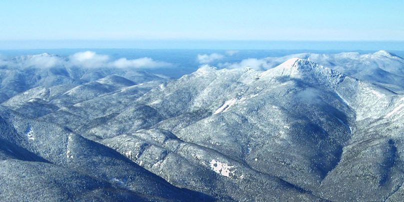 An aerial view of several snow covered mountain peaks